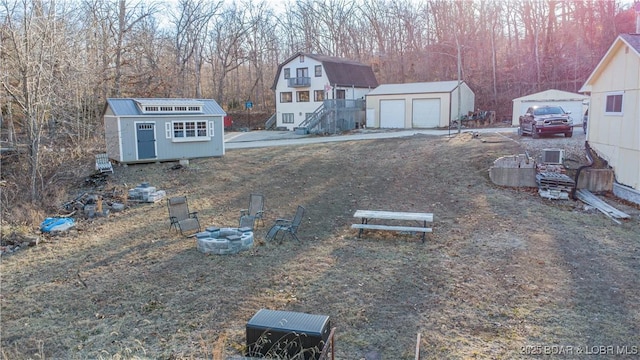 view of yard with a garage and a storage shed