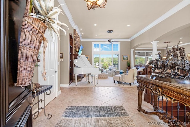 tiled entryway with crown molding, decorative columns, and ceiling fan