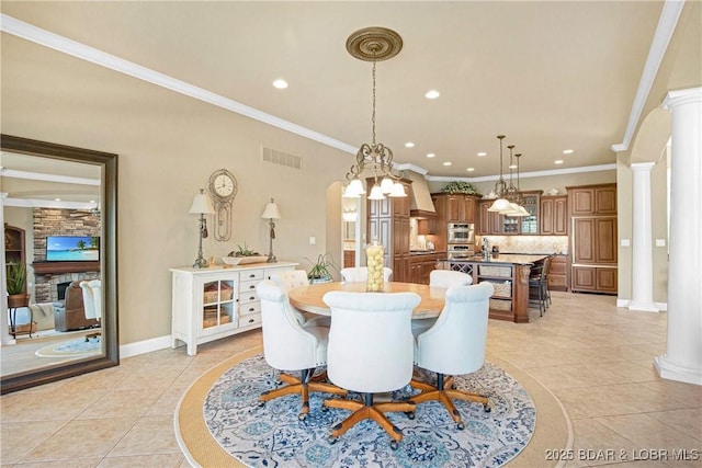 tiled dining area with ornate columns and ornamental molding