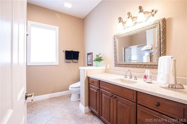 bathroom featuring vanity, a shower with shower door, tile patterned floors, and toilet