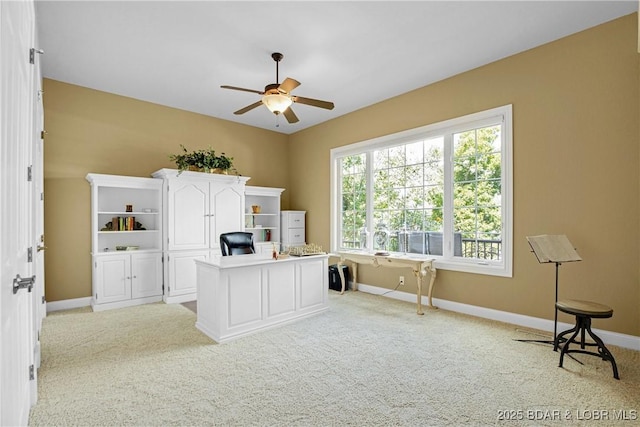 home office featuring light colored carpet and ceiling fan