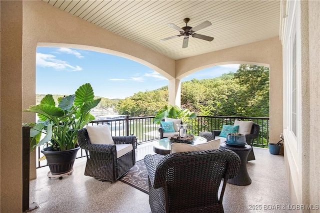 balcony with ceiling fan and an outdoor living space