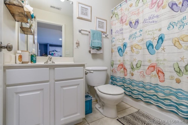 bathroom with walk in shower, tile patterned floors, toilet, and vanity