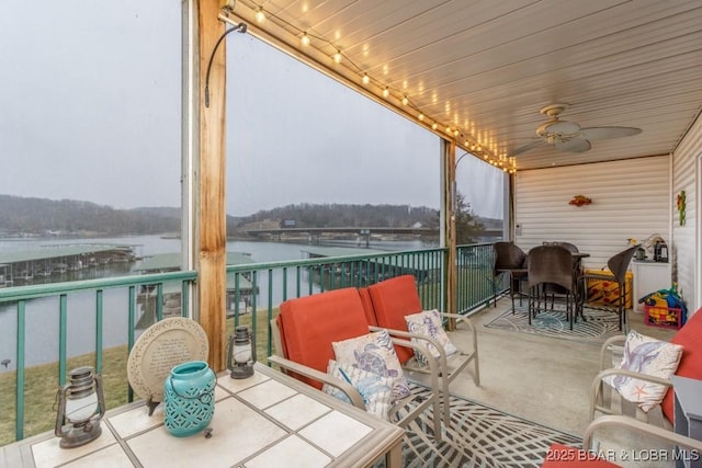 exterior space featuring a water view and ceiling fan