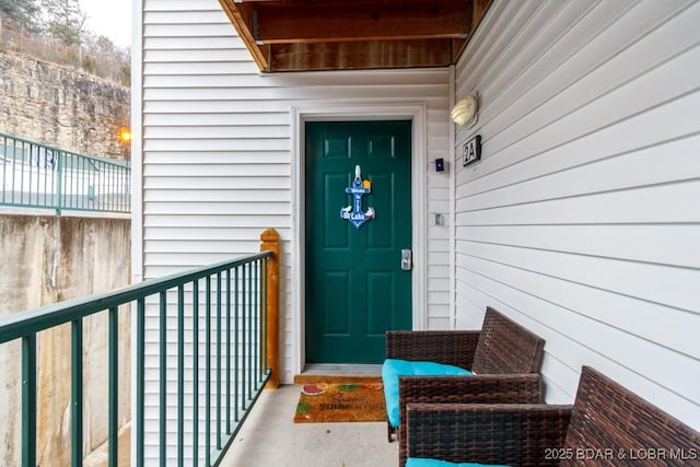 view of exterior entry featuring a balcony