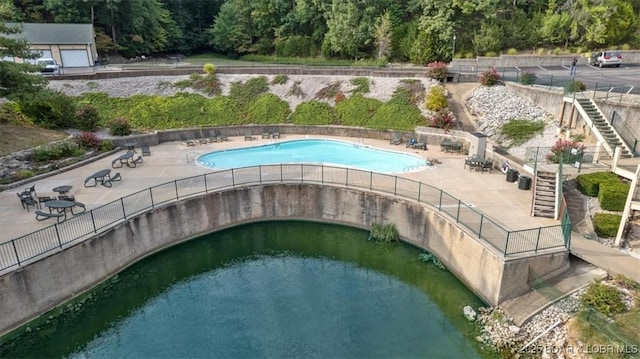 view of swimming pool featuring a patio area