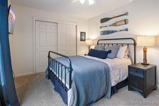 bedroom with ceiling fan, a closet, and light carpet