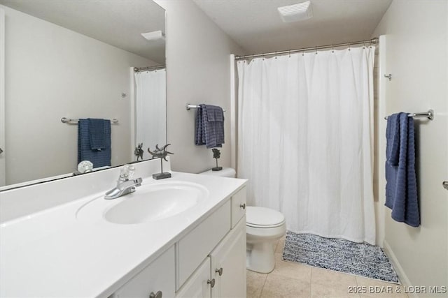 bathroom featuring tile patterned flooring, vanity, and toilet