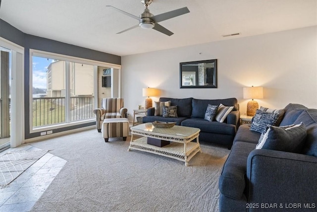 carpeted living room with ceiling fan