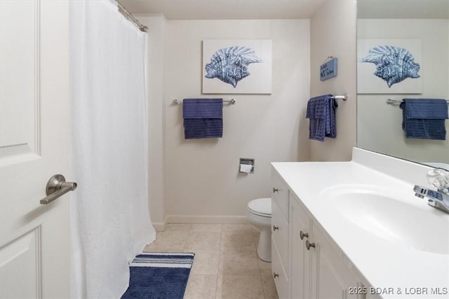 bathroom featuring vanity, tile patterned floors, and toilet