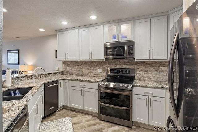 kitchen featuring white cabinetry, sink, and appliances with stainless steel finishes