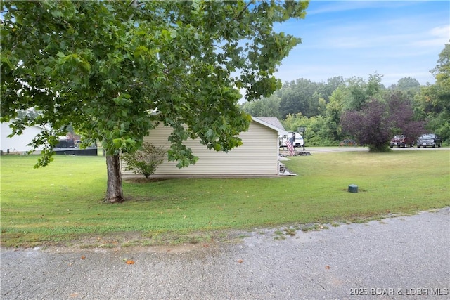 view of side of home with a lawn