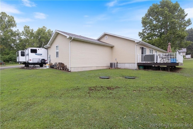 view of home's exterior featuring a wooden deck, a yard, and central air condition unit