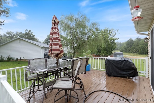 deck with area for grilling and a yard