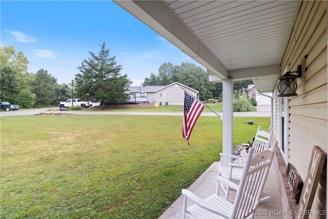 view of yard with covered porch