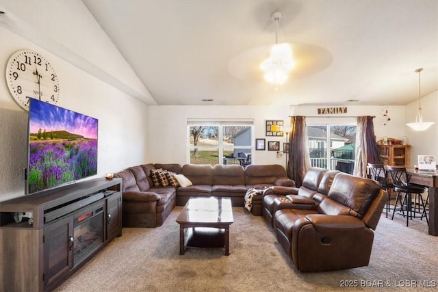 living room featuring vaulted ceiling, ceiling fan, and carpet flooring