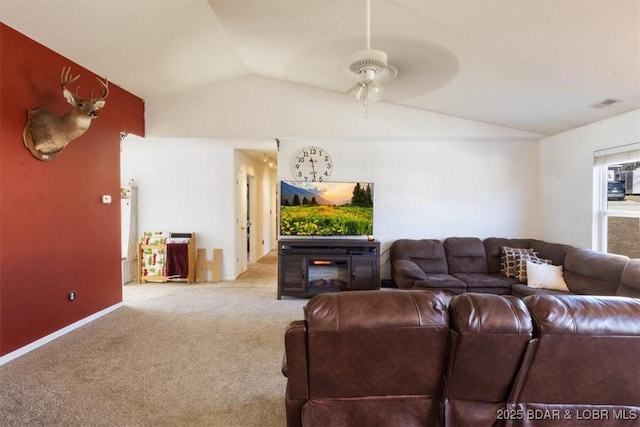 living room featuring vaulted ceiling, light colored carpet, and ceiling fan