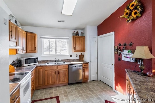 kitchen featuring white appliances and sink