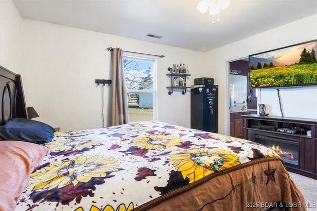 bedroom featuring connected bathroom and carpet floors