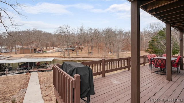 wooden terrace with a grill