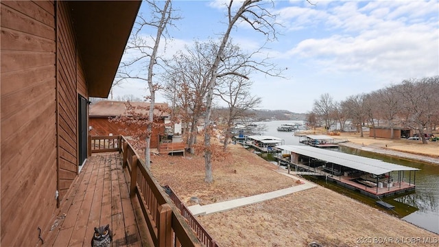 view of yard featuring a dock and a water view