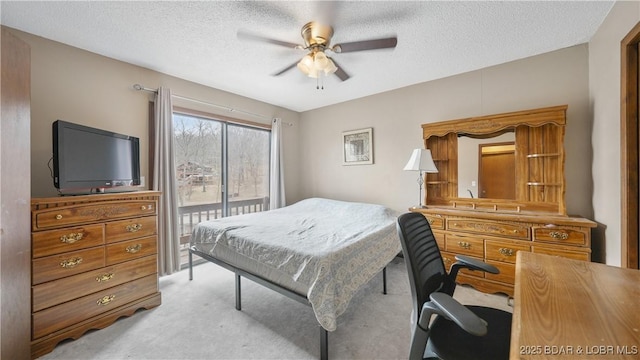 carpeted bedroom with ceiling fan, access to outside, and a textured ceiling