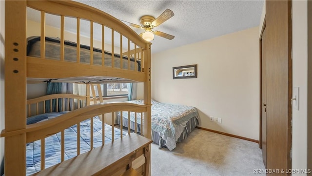 bedroom with light colored carpet and a textured ceiling