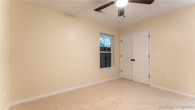 unfurnished bedroom with ceiling fan and light carpet