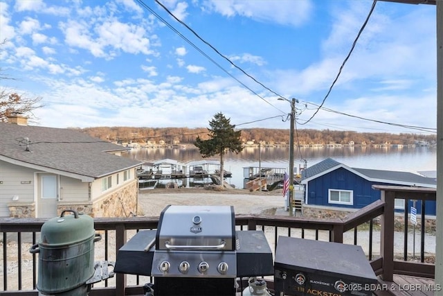 wooden deck featuring a water view and area for grilling