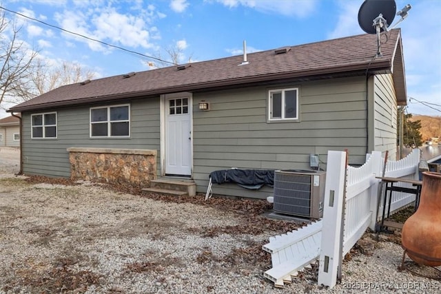 rear view of property featuring central AC unit