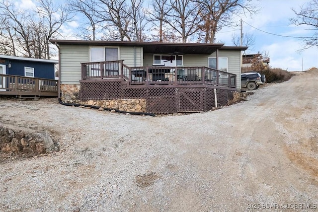 back of house featuring a deck