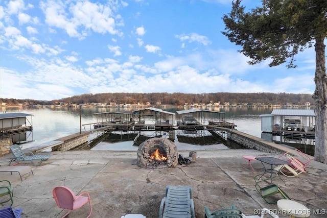 dock area with a water view and an outdoor fire pit