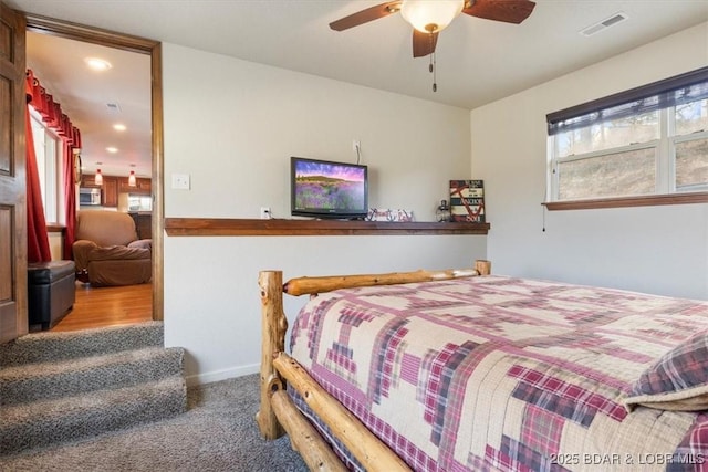 bedroom featuring ceiling fan and carpet