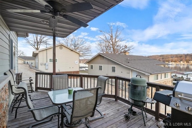 wooden deck featuring area for grilling and ceiling fan