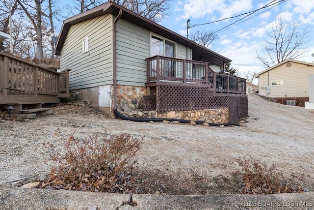 exterior space featuring a wooden deck and central AC unit