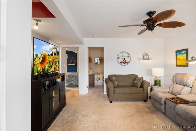 carpeted living room featuring ceiling fan