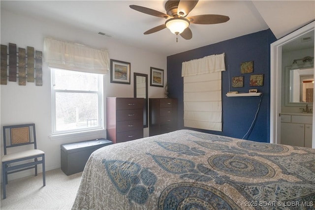 bedroom with ceiling fan, sink, and carpet floors