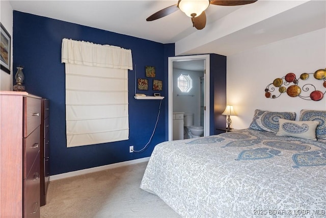 carpeted bedroom with ensuite bathroom and ceiling fan