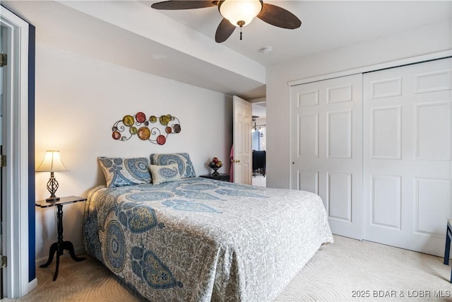 bedroom with ceiling fan, carpet flooring, and a closet