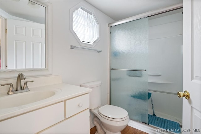 bathroom with vanity, toilet, and walk in shower