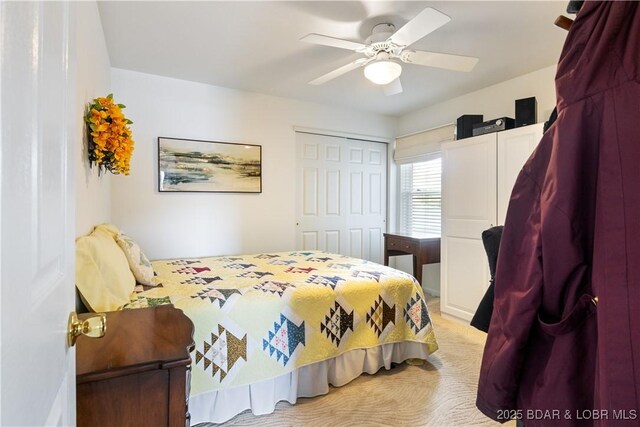 carpeted bedroom with ceiling fan and a closet