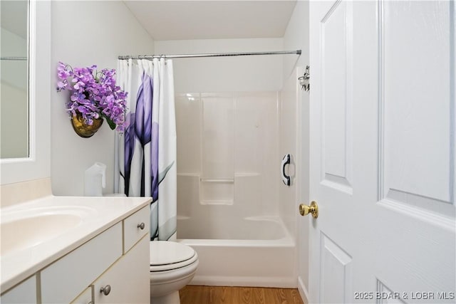 full bathroom with vanity, toilet, hardwood / wood-style floors, and shower / bath combo