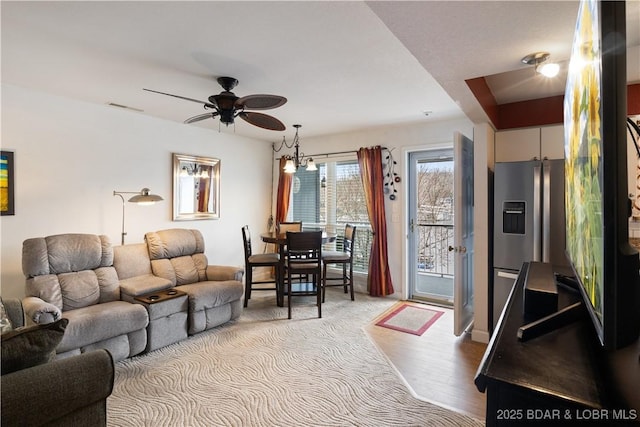 living room with ceiling fan and light hardwood / wood-style flooring