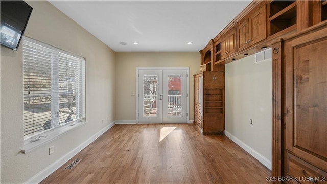 interior space featuring light hardwood / wood-style floors and french doors