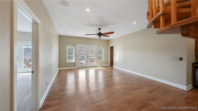 unfurnished living room featuring french doors, ceiling fan, and wood-type flooring