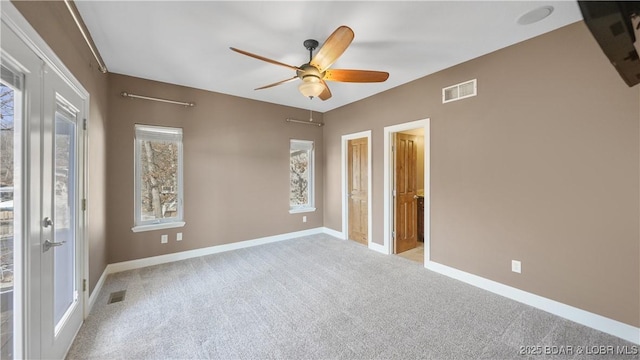 carpeted empty room featuring french doors and ceiling fan