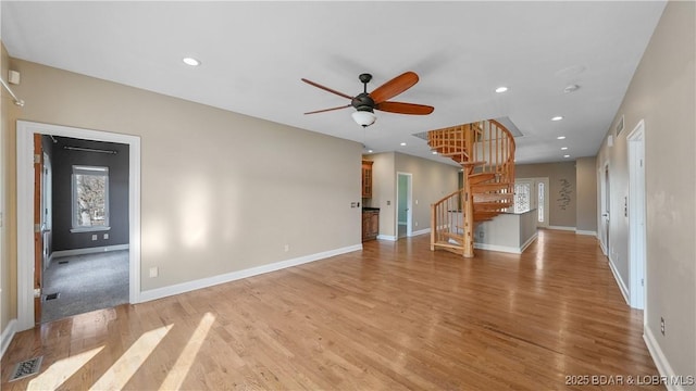 unfurnished living room featuring wood-type flooring and ceiling fan