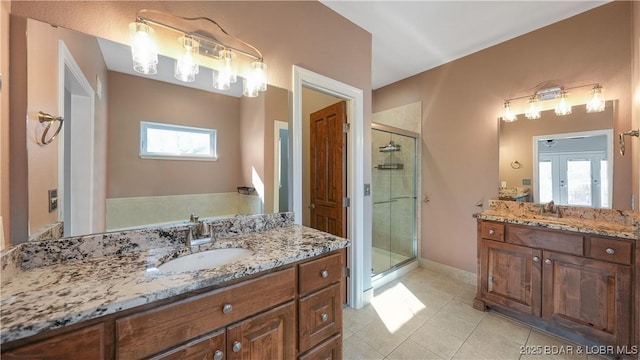 bathroom featuring vanity, tile patterned floors, and walk in shower