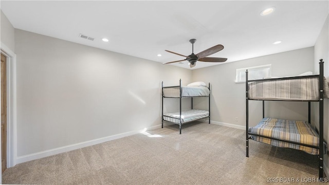 unfurnished bedroom with ceiling fan and light carpet