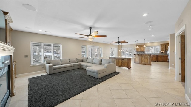 living room featuring light tile patterned floors and ceiling fan